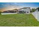 Backyard features a white fence, spacious lawn, and screened in porch at 1933 Fruitridge St, Brandon, FL 33510