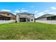 Spacious backyard with a well-maintained lawn and covered patio area at 1933 Fruitridge St, Brandon, FL 33510