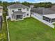 Well-manicured backyard with white fence, spacious lawn, and screened in porch at 1933 Fruitridge St, Brandon, FL 33510