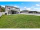 Large backyard showcasing lush green grass and a screened-in lanai at 1933 Fruitridge St, Brandon, FL 33510