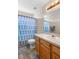 Bathroom featuring a wood vanity and a blue shower curtain at 1933 Fruitridge St, Brandon, FL 33510