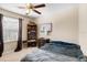 Bedroom featuring a ceiling fan, window, and dark furniture at 1933 Fruitridge St, Brandon, FL 33510