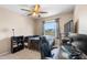 Bedroom featuring a ceiling fan, window, and black desk at 1933 Fruitridge St, Brandon, FL 33510