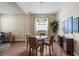 Well-lit dining area features hardwood floors, modern chandelier, and ample natural light for an inviting atmosphere at 1933 Fruitridge St, Brandon, FL 33510