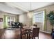 Open floor plan showcases the combined dining and living area with hardwood floors and modern lighting at 1933 Fruitridge St, Brandon, FL 33510