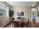 Elegant dining area features hardwood floors, a chandelier, and large window with natural light at 1933 Fruitridge St, Brandon, FL 33510