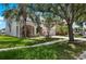 Beautiful home with mature trees, lush green lawn, and ample parking at 1933 Fruitridge St, Brandon, FL 33510