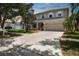 Charming two-story home featuring a well-manicured lawn, complemented by mature trees and lush landscaping at 1933 Fruitridge St, Brandon, FL 33510