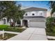 Charming two-story home featuring a well-manicured lawn, neutral paint, shutters, and an attached two-car garage at 1933 Fruitridge St, Brandon, FL 33510