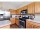 Kitchen with stainless steel appliances, wooden cabinets, and lots of counter space at 1933 Fruitridge St, Brandon, FL 33510