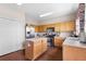 Bright kitchen features wood cabinets, stainless steel appliances, an island and hardwood flooring at 1933 Fruitridge St, Brandon, FL 33510