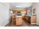 Functional kitchen featuring wooden cabinets, stainless steel appliances, and a central island at 1933 Fruitridge St, Brandon, FL 33510