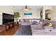 Cozy living room features hardwood floors, a ceiling fan, and a plush sectional couch at 1933 Fruitridge St, Brandon, FL 33510