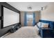 Spacious home theater with projector, screen, plush seating and a sunlit window at 1933 Fruitridge St, Brandon, FL 33510