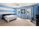 Bright main bedroom with a king bed, natural light, and carpet flooring at 1933 Fruitridge St, Brandon, FL 33510