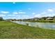 Scenic view of a tranquil pond surrounded by lush green grass at 1933 Fruitridge St, Brandon, FL 33510