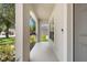 Covered front porch with tile flooring and a view of the landscaped yard at 1933 Fruitridge St, Brandon, FL 33510
