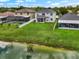Aerial view of backyard featuring a pond, a pool and a screened in porch at 1933 Fruitridge St, Brandon, FL 33510