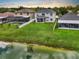 Aerial view of backyard featuring a pond, a pool and a screened in porch at 1933 Fruitridge St, Brandon, FL 33510