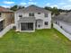 Aerial view of fenced backyard with screened porch and bay window at 1933 Fruitridge St, Brandon, FL 33510