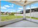 Screened patio with view of large backyard, pond and surrounding houses at 1933 Fruitridge St, Brandon, FL 33510