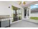 Covered and screened patio with grill and view of the fenced backyard at 1933 Fruitridge St, Brandon, FL 33510