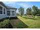 Landscaped backyard offers serene views of the pond and neighboring trees at 212 Shell Creek Ct, Apollo Beach, FL 33572