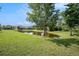 Picturesque backyard view showcasing a serene pond surrounded by lush greenery and mature trees at 212 Shell Creek Ct, Apollo Beach, FL 33572