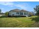 Beautiful backyard featuring a screened-in porch, well-kept lawn, and mature landscaping at 212 Shell Creek Ct, Apollo Beach, FL 33572