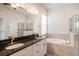 Bathroom features double sinks, granite countertops, a tub, and a separate shower at 212 Shell Creek Ct, Apollo Beach, FL 33572