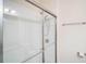 Bathroom shower featuring a glass door and brushed metal fixtures, with tile walls at 212 Shell Creek Ct, Apollo Beach, FL 33572