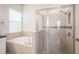 Bright bathroom features a tub and a separate tiled shower at 212 Shell Creek Ct, Apollo Beach, FL 33572