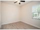 Bedroom features wood-look tile flooring and a window providing natural light at 212 Shell Creek Ct, Apollo Beach, FL 33572