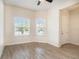 Inviting bedroom showcasing tile flooring, two windows, and neutral decor at 212 Shell Creek Ct, Apollo Beach, FL 33572