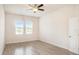 Bright bedroom with wood-look tile flooring and two windows at 212 Shell Creek Ct, Apollo Beach, FL 33572
