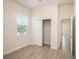Bright bedroom with wood-look tile flooring, closet, and a window with views at 212 Shell Creek Ct, Apollo Beach, FL 33572