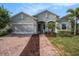 Charming single-Gathering home featuring a brick driveway and lush landscaping at 212 Shell Creek Ct, Apollo Beach, FL 33572