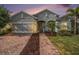 Charming single-Gathering home featuring a brick driveway and lush landscaping at 212 Shell Creek Ct, Apollo Beach, FL 33572