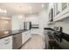 Kitchen with stainless steel appliances, granite countertops and a large island featuring a sink at 212 Shell Creek Ct, Apollo Beach, FL 33572