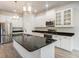 Modern kitchen featuring granite counters, stainless appliances, and island with pendant lighting at 212 Shell Creek Ct, Apollo Beach, FL 33572