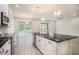Bright, open kitchen with island, stainless steel appliances, and sliding glass doors to outdoor space at 212 Shell Creek Ct, Apollo Beach, FL 33572
