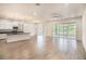 Expansive living room featuring recessed lights, a kitchen bar, and doors to the lanai at 212 Shell Creek Ct, Apollo Beach, FL 33572