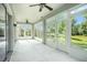 Bright sunroom with ceiling fans and lots of windows overlooking the lush backyard and pond at 212 Shell Creek Ct, Apollo Beach, FL 33572