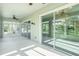 Spacious sunroom featuring sliding glass doors and ceiling fans for year-round enjoyment at 212 Shell Creek Ct, Apollo Beach, FL 33572