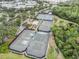Aerial view of the community tennis courts surrounded by lush greenery at 212 Shell Creek Ct, Apollo Beach, FL 33572