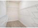 Large walk-in closet with built-in shelving and wood-look tile flooring at 212 Shell Creek Ct, Apollo Beach, FL 33572