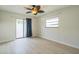Neutral bedroom with ample natural light, sliding glass doors, and wood-look flooring at 2204 78Th W St, Bradenton, FL 34209