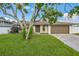 Charming home featuring a well-manicured lawn, mature trees, and a two-car garage at 2204 78Th W St, Bradenton, FL 34209