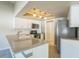 Bright kitchen features a stylish gray countertop, white cabinets, and stainless steel appliances at 2204 78Th W St, Bradenton, FL 34209