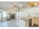 Open-concept kitchen featuring a breakfast bar, fireplace, and modern appliances at 2204 78Th W St, Bradenton, FL 34209
